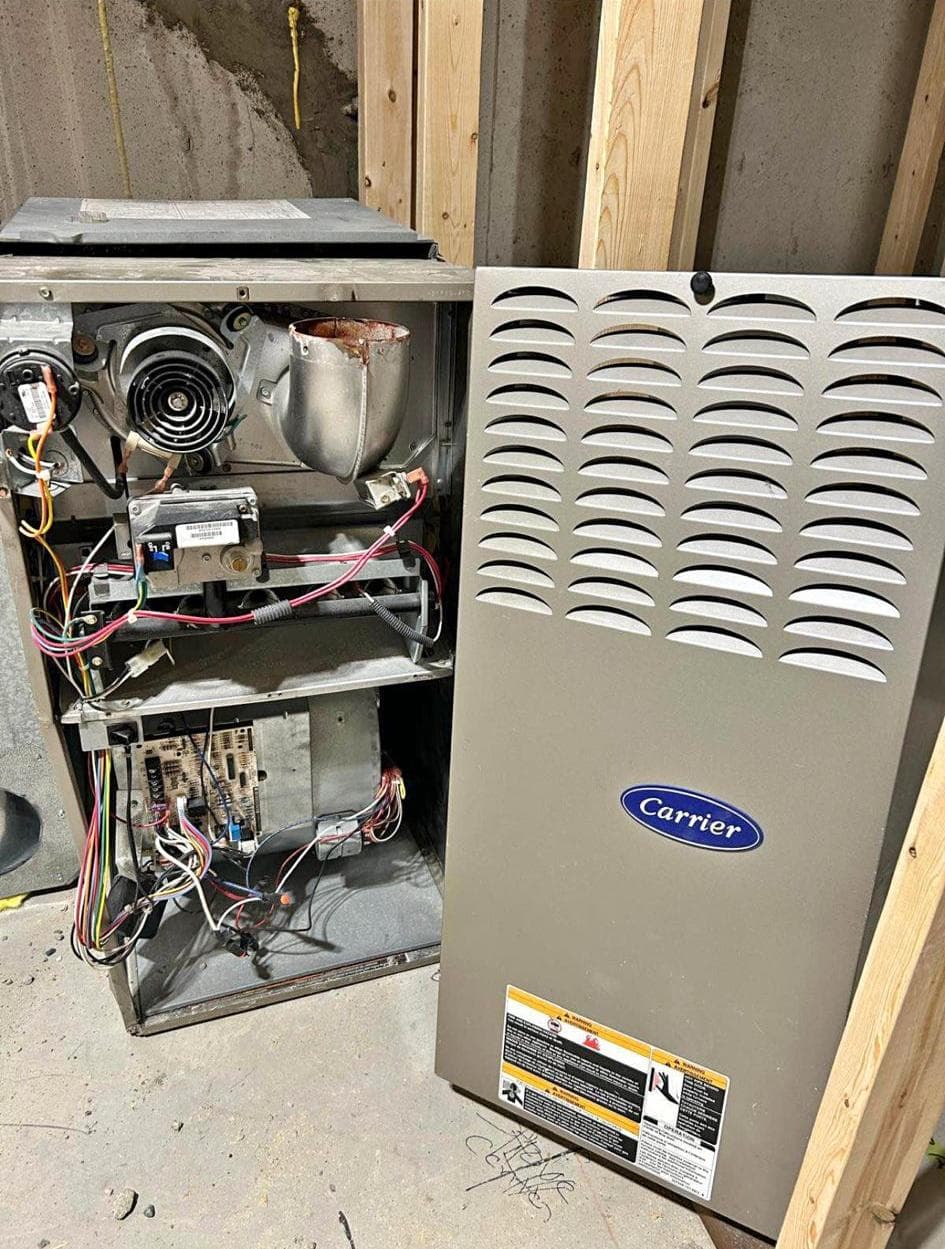 Carrier furnace open for professional repair by Aaron Cold Tech technicians