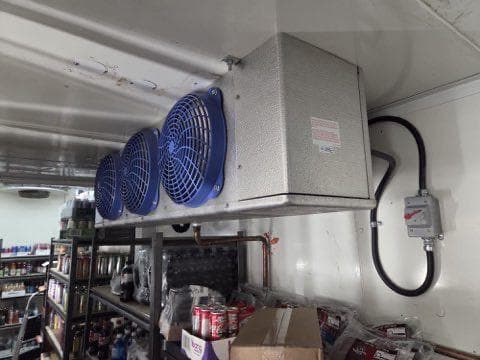 Walk-in cooler evaporator with blue fans installed in a convenience store by Aaron Cold Tech
